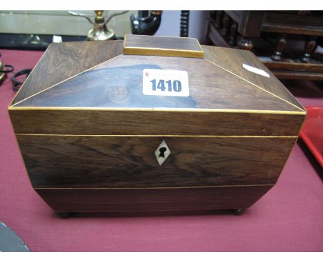 An Early XIX Century Rosewood Tea Caddy, of sarcophagus form, boxwood stringing, on ball feet.