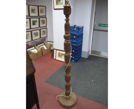 A Hardwood Indian Standard Lamp, circa mid XX Century, heavily carved with animals amongst foliage, on circular base.