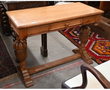 A Jacobean style golden oak console cable with single drawer and cup and cover carved column supports, 96 cm w x 47 cm d x 73