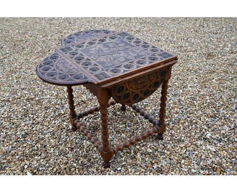 A carved and poker-worked drop leaf side table with floral and foliate designs, bobbin turned supports and stretchers, 100 x 