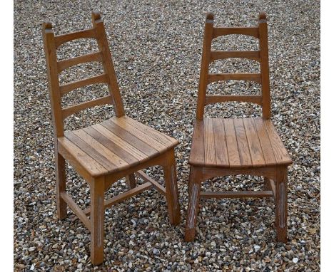 A set of six limed oak Arts &amp; Crafts style dining chairs with tapered ladder backs, slatted seats and fluted supports uni
