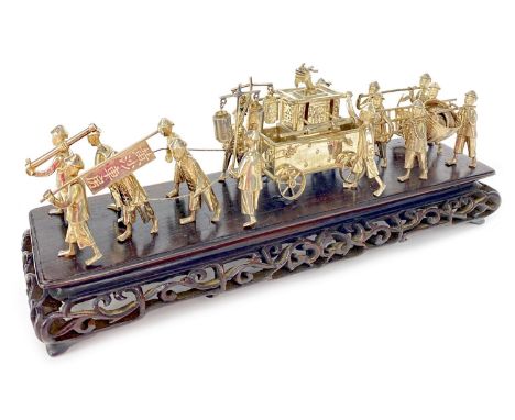 CHINESE WHITE METAL MODEL OF A PROCESSION, formed with figures and a carriage, on a wood stand with carved and pierced frieze