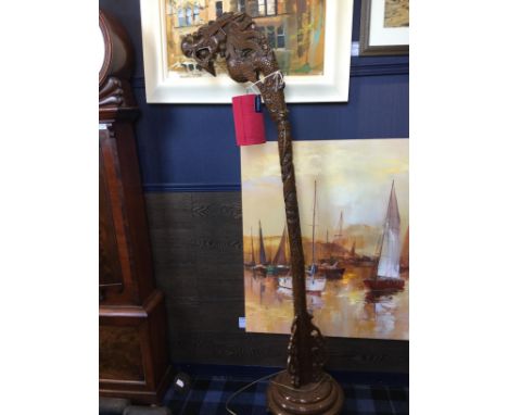 20TH CENTURY CHINESE CARVED WOOD STANDARD LAMP, modelled with a dragon's head to the top, the carved 'body' on a stepped circ