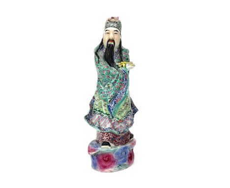 20TH CENTURY CHINESE CERAMIC FIGURE, the male modelled standing holding scrolls, with floral decorated robes, 40.5cm high