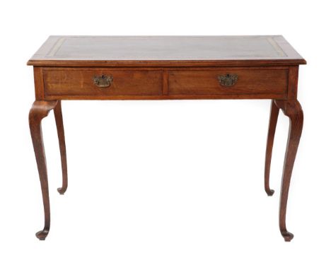 ~ A Two-Drawer Oak Writing Table, the later green and gilt leather skiver above two frieze drawers, on cabriole legs with pad