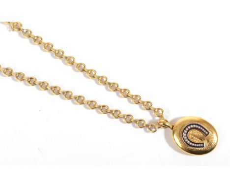 A Victorian Locket Pendant, with seed pearl horseshoe motif within a blue enamel frame, over engraved detail, on a fancy link