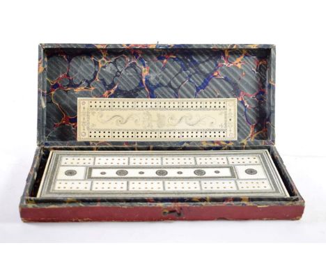 An Anglo-Indian Ivory and Sedeli Cribbage Board, mid 19th century, with foliate decoration on turned feet, with two markers, 