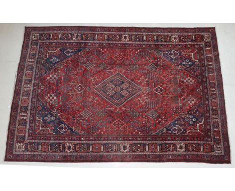 Joshagan Carpet Central Iran, circa 1920 The madder field of geometric plants around a stepped diamond medallion framed by sp