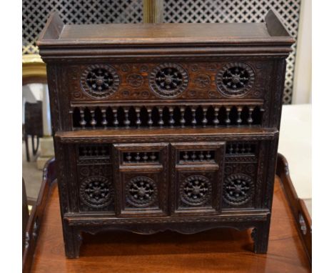 A Carved Walnut Cupboard, late 19th/early 20th century, in 17th century style, the moulded top above a balustrade panel and s