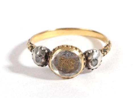 A Mourning Ring, circa 1800, a faceted rock crystal cover entwined hair and a monogram, in a yellow collet setting, flanked b