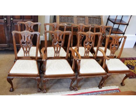 ~ A Set of Eight Carved Mahogany Chippendale Revival Dining Chairs, 20th century, including two carvers, the carved top rails