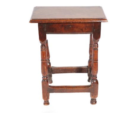 ^ An 18th Century Oak Joint Stool, the later top above a moulded apron, on turned spindle supports with block feet joined by 