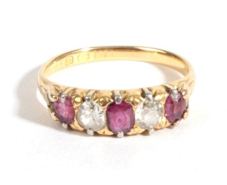 A Late Victorian 18 Carat Gold Ruby and Diamond Five Stone Ring, three graduated cushion cut rubies alternate with old cut di