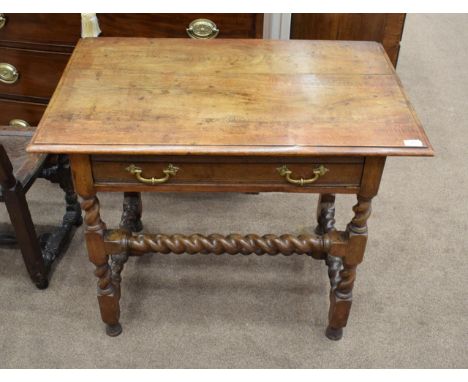 An Oak Side Table, the moulded top above a long frieze drawer raised on spiral and block legs, joined by a H stretcher, 89cm 