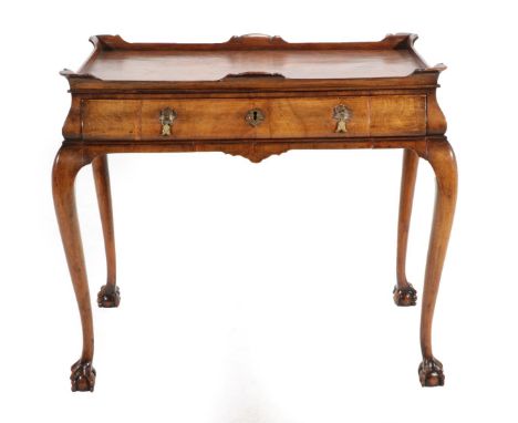 A 1920's Walnut Side Table, the moulded top above a long frieze drawer, on cabriole legs with carved claw feet, 89cm by 59cm 