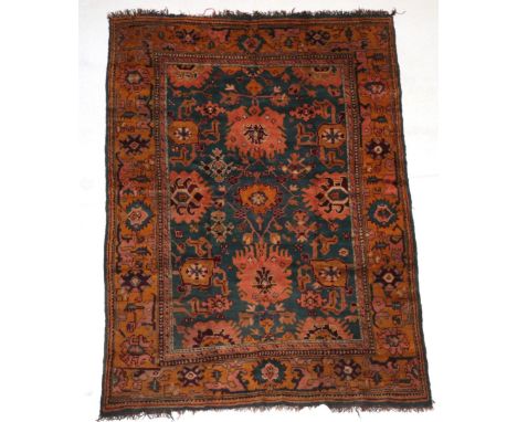 Ushak Carpet  Central West Anatolian, circa 1900 The turquoise field of Harshang motifs and large flower heads enclosed by wi