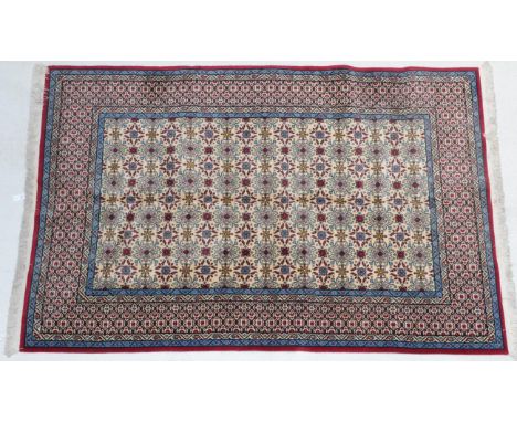Indian Carpet, modern The cream ground of 'boteh' enclosed by lattice borders, 300cm by 205cm.  In good condition.