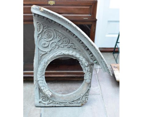 A Carved Walnut Pediment Fragment, probably 17th century, of broken arch form carved with a laurel wreath and scrolling folia