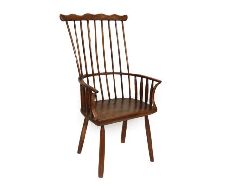 A Late 18th Century Provincial Yewwood Stick-Back Armchair, the comb shaped top rail above double spindles and curved arm res