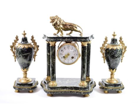 {} A Green Marble Striking Portico Mantel Clock with Garniture, early 20th century, case surmounted with a lion, 3-1/2-inch e