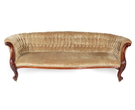 A Victorian Carved Mahogany Three-Seater Sofa, circa 1870, upholstered in button beige velvet, the overstuffed back support a