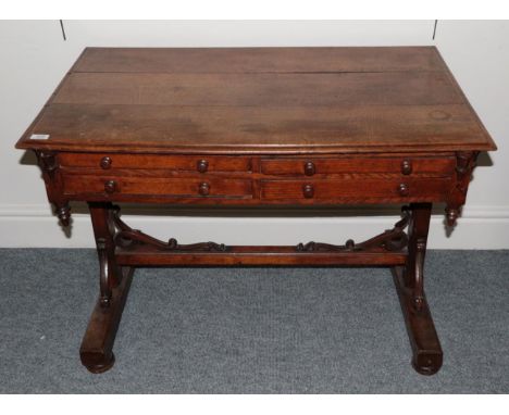 A Victorian Oak Side Table, late 19th century, the moulded top above four small frieze drawers, on standard ends supports wit