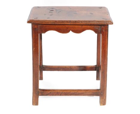 ^ An Oak Joint Stool, 3rd quarter 18th century, the moulded top above a wavy shaped apron, on square chamfered legs joined by