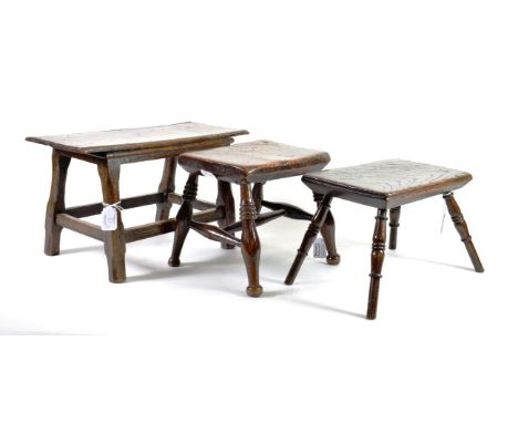 ^ An Oak Small Stool, 18th century, on turned legs tied by a stretcher, 41.5cm wide; and Two Similar Stools, 19th century, wi