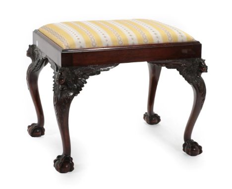 A Carved Mahogany Dressing Stool, late 19th/early 20th century, with a yellow and white stripped overstuffed drop-in seat, on