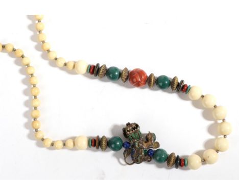 A Chinese Ivory, Coral and Enamel Necklace, graduated round ivory beads, a shaped coral and other coral beads and aventurine 