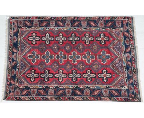 ~ Dosemalti Carpet West Turkey, modern The crimson field with hooked medallions and cruciform guls enclosed by indigo borders
