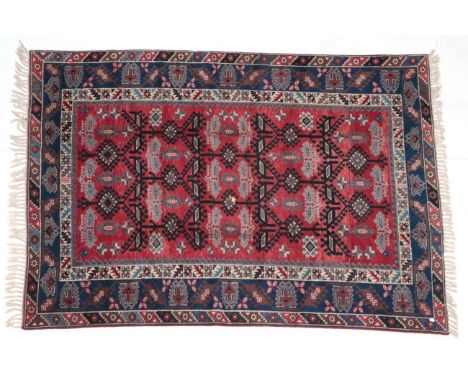 ~ Dosemalti Carpet West Turkey, modern The crimson latch hook lattice field enclosed by indigo borders, 283cm by 196cmIn good
