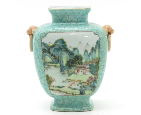 Light green ground decorated with two landscape scenes in Famille Rose enamels, temple lion handles, Qianlong mark, 21 cm. ta