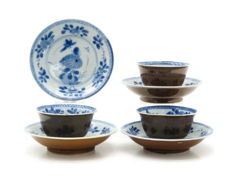 Including four saucers and three cups in blue and white floral decor, marked with double ring and lozenge.