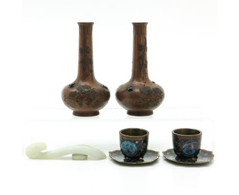 Including two vases, two cloisonne cups and saucers, and a jade hook, small pieces of decor missing on vases.  Metal vases ar