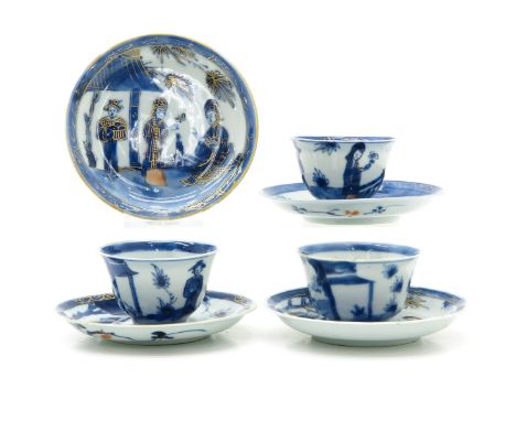Blue and white decor with gilt accents, saucers are 10 cm. in diameter, with chip and hairline.