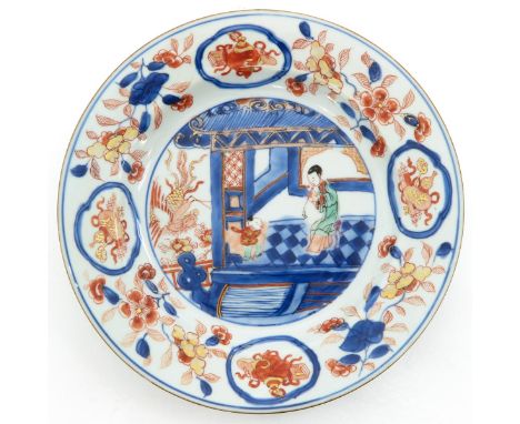 In iron red, blue and gilt enamels depicting scene in pagoda in center of plate, floral decor on border, 23 cm. in diameter, 
