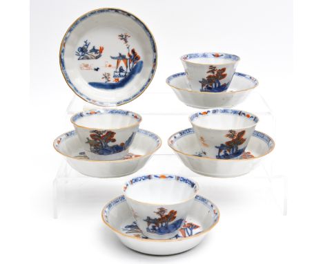 In iron red, blue and gilt enamels depicting scene in garden with Chinese figure, saucers are 12 cm. in diameter. 