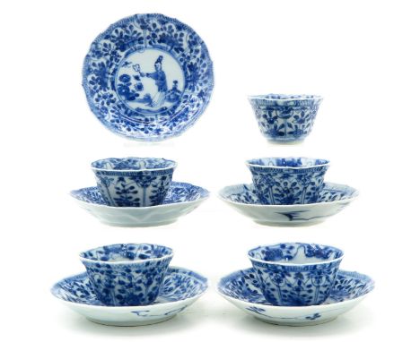 Blue and white decor depicting Chinese figure in garden, saucers are 11 cm. in diameter.