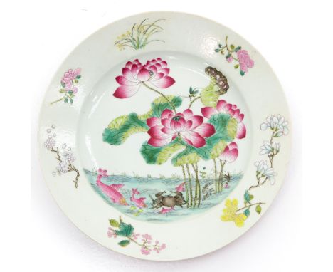 Decorated with flowers and sea animals in Famille Rose enamels with ruby back, 23 cm. in diameter, restored.