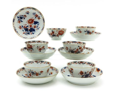 Imari floral decor in Iron red, blue and gilt accents, 18th Century, saucers are 13 cm. in diameter, some with chip and hairl