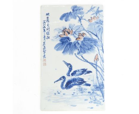 Decorated with flowers, ducks and Chinese text and seal marks in Iron red and blue enamels, tile measures 54 x 32 cm.