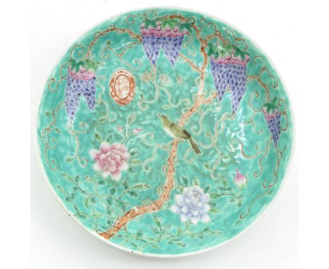 Light green ground depicting bird in tree with grape vines in Famille Rose enamles, with Chinese text and seal mark, 23 cm. i