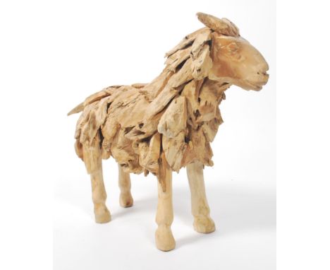 A stunning 20th century sculpture of a long fleeced ram, constructed entirely from reclaimed timber horns to the head, entwin