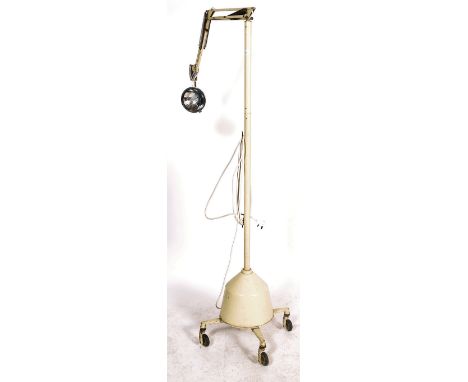 A mid century large floorstanding medical - theatre anglepoise lamp light. Of large form with cream enamel painted body havin