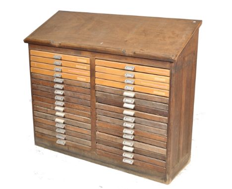 An early 20th century large Industrial oak 32 drawer printers filing cabinet / draughtsmans board. The large chest with plint