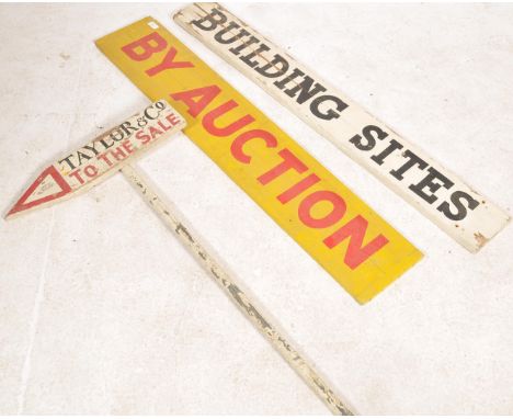 A collection of vintage wooden mid century auction advertising signs. To include a yellow and red long wooden double sided si