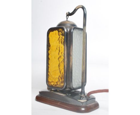 A mid century / 1950's  table lamp raised on mahogany base with polished steel plinth having a mottled glass hanging lantern 