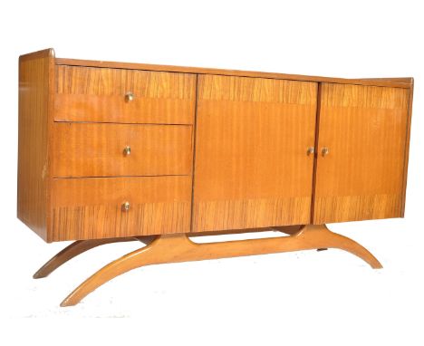 A retro mid century cross banded mahogany and walnut sideboard by Harry Lebus for Lebus Furniture. Raised on a arched, turned