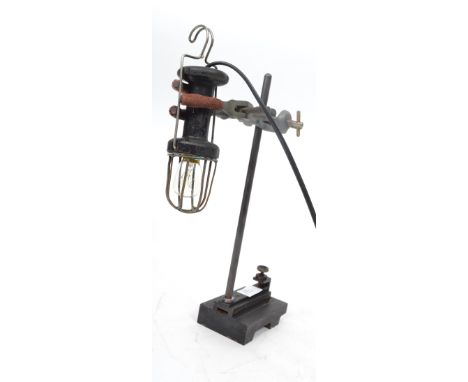 A vintage retro 20th century wooden car inspection lamp having a wire cage mounted on an adjustable clamp laboratory stand on
